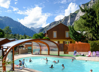 Une piscine extérieure avec terrasse et transats par beau temps