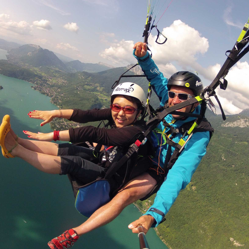 Tandem paragliding flight above lake Annecy